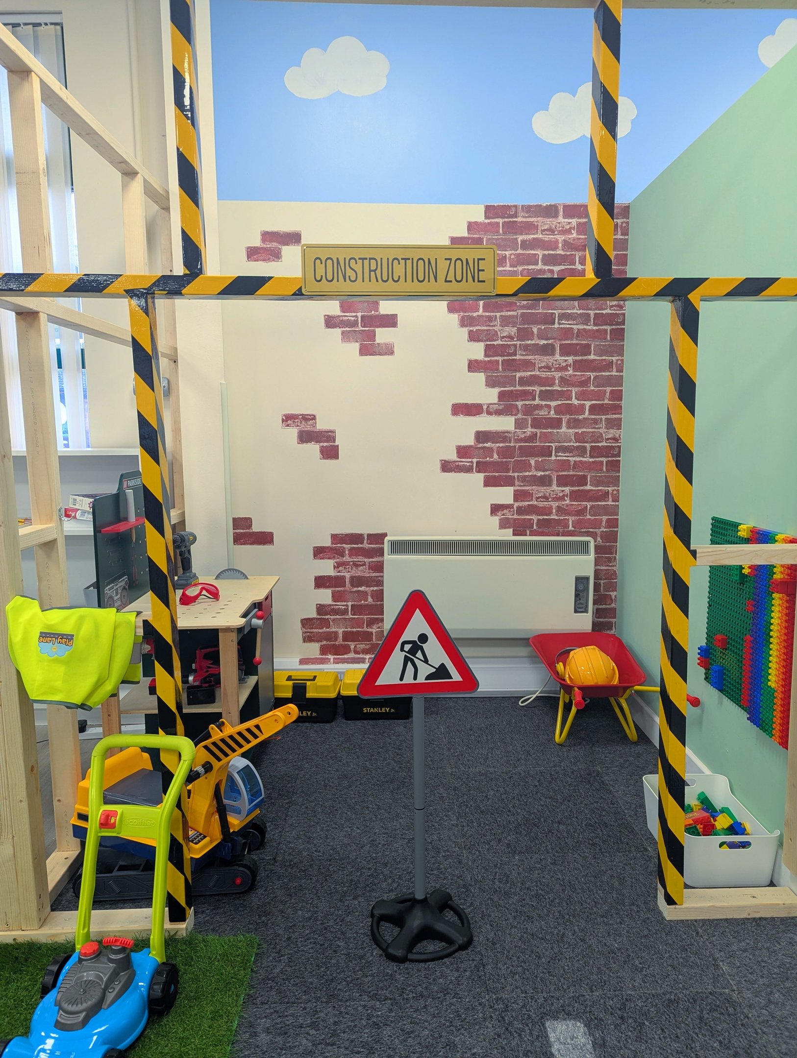 The construction zone with tools, bricks and a wheelbarrow